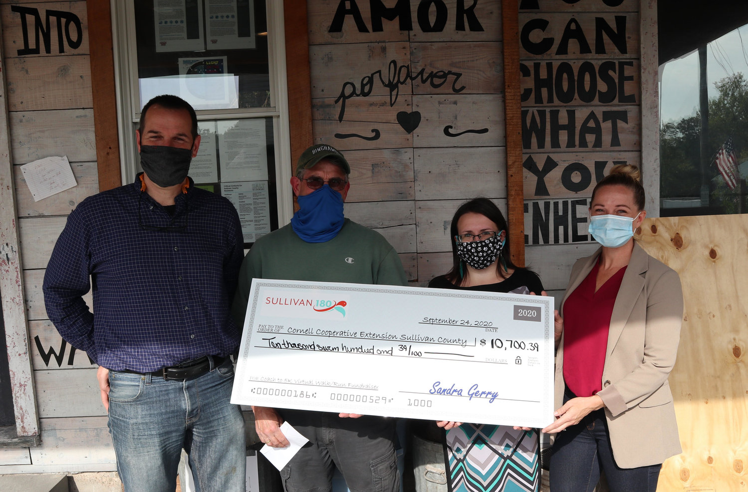 Thomas Bosket, left, Martin Colavito, Jenny Sanchez and Meaghan Mullally-Gorr pose with a check for $10,700 for Sullivan Allies Leading Together (SALT). The money was brought in by a fundraiser organized by Sullivan 180.